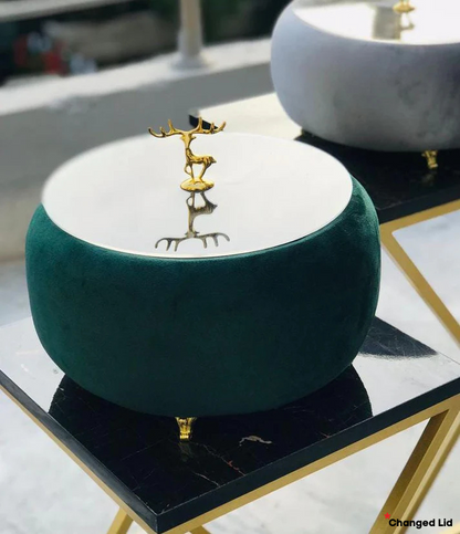 Green Turkish Hotpot with a gold deer figurine on a marble surface
